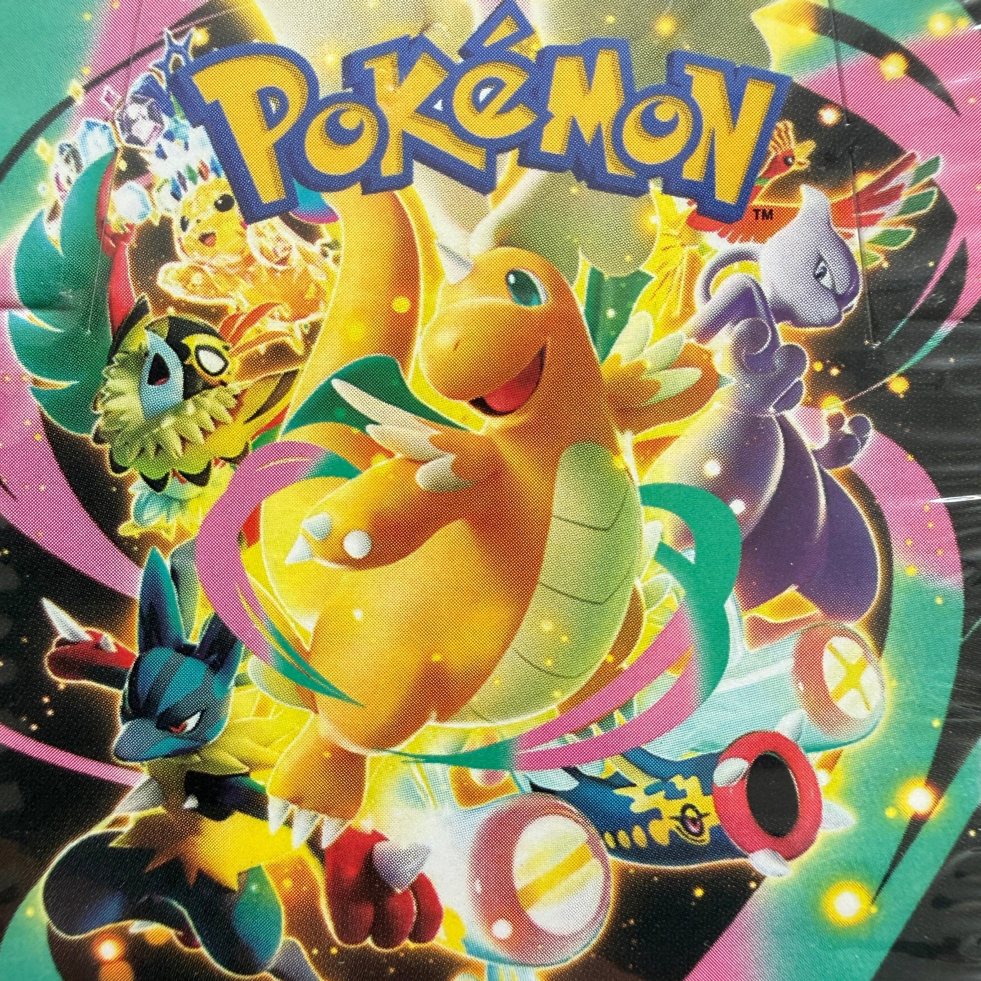 Pokémon artwork featuring dragonite in the center, surrounded by other recognizable Pokémon creatures including Mewtwo, and Pikachu, with the large Pokémon logo at the top and a colorful swirling background.